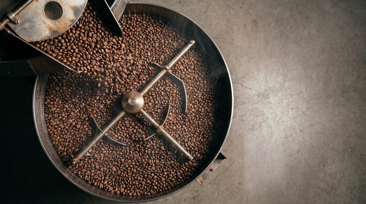 Top view of freshly roasted coffee beans turning in the roaster tray