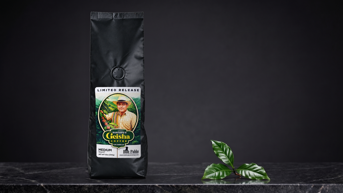 A bag of Gustavo’s Geisha beside a sprig of coffee leaves